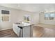 Kitchen island with stainless steel dishwasher in a spacious, bright living area at 3003 Pershing St, Strasburg, CO 80136