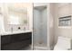 Updated bathroom with double vanity and a glass shower enclosure at 6620 E Virginia Ave, Denver, CO 80224