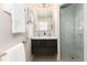 Modern bathroom with double vanity, glass shower, and updated fixtures at 6620 E Virginia Ave, Denver, CO 80224