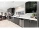 Sleek kitchen featuring dark gray cabinetry and a stainless steel dishwasher at 6620 E Virginia Ave, Denver, CO 80224