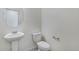 Powder bathroom with pedestal sink, large mirror, and standard toilet at 27604 E Byers Ave, Aurora, CO 80018