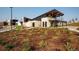 Exterior shot of a modern community clubhouse with desert landscaping and a manicured lawn at 27604 E Byers Ave, Aurora, CO 80018