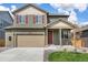 Charming two-story home with attached two car garage, red front door and red shutters at 27604 E Byers Ave, Aurora, CO 80018