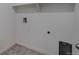 Bright laundry room featuring tile floor, utility hookups, and convenient shelving for storage solutions at 27604 E Byers Ave, Aurora, CO 80018