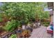 Inviting backyard patio features a wooden deck, lush landscaping, and a serene outdoor dining area at 21063 E Greenwood Pl, Aurora, CO 80013