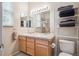 Bathroom featuring double sinks, a large mirror, and natural lighting with a separated shower stall at 21063 E Greenwood Pl, Aurora, CO 80013
