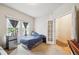 Well-lit bedroom boasts large windows, a mini-fridge, and ample space for relaxation and personalization at 21063 E Greenwood Pl, Aurora, CO 80013
