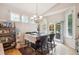 Bright dining area with modern lighting and access to the outdoor space at 21063 E Greenwood Pl, Aurora, CO 80013