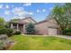 Charming brick home with a well-manicured lawn and mature landscaping at 21063 E Greenwood Pl, Aurora, CO 80013
