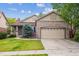 Beautiful brick home with a two-car garage and well-kept front yard at 21063 E Greenwood Pl, Aurora, CO 80013