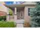 Inviting front porch of a brick home, featuring a cozy entrance at 21063 E Greenwood Pl, Aurora, CO 80013
