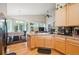 Open kitchen and dining area with wood floors, stainless appliances, and ample light at 21063 E Greenwood Pl, Aurora, CO 80013