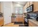 Efficient kitchen with stainless steel appliances, a sink, and tile backsplash at 21063 E Greenwood Pl, Aurora, CO 80013