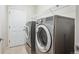 Well-equipped laundry room featuring modern machines for efficient and convenient laundry care at 21063 E Greenwood Pl, Aurora, CO 80013