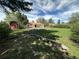 Large grassy backyard and shed featuring beautiful landscaping at 1836 E Mineral Ave, Centennial, CO 80122