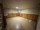 The unfinished basement features paneled walls, built-in cabinets and a window at 1836 E Mineral Ave, Centennial, CO 80122