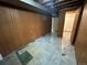 The unfinished basement features paneled walls, tile flooring and an entrance to another room at 1836 E Mineral Ave, Centennial, CO 80122