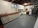 Unfinished basement space with cabinets and a water heater at 1836 E Mineral Ave, Centennial, CO 80122