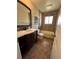 Bathroom with a single sink vanity, decorative tile, and combined tub and shower at 1836 E Mineral Ave, Centennial, CO 80122