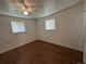 This bedroom features hardwood floors, a ceiling fan, and lots of natural light from two windows at 1836 E Mineral Ave, Centennial, CO 80122