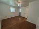 This bedroom features hardwood floors, a ceiling fan, and a double door closet at 1836 E Mineral Ave, Centennial, CO 80122