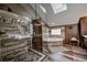 Well-lit bathroom with stone accents, glass shower, soaking tub, and wood-look flooring at 185 S Fuller Placer Rd, Breckenridge, CO 80424