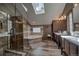 Bright bathroom featuring a glass enclosed shower, soaking tub, and dual sink vanity with updated fixtures at 185 S Fuller Placer Rd, Breckenridge, CO 80424