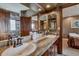 Bright bathroom with double sinks, stone countertops, wood trim, and access to the shower at 185 S Fuller Placer Rd, Breckenridge, CO 80424