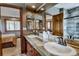 Spacious bathroom features a double sink vanity, stone countertops, and an ornate wood trim at 185 S Fuller Placer Rd, Breckenridge, CO 80424
