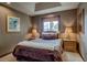 Cozy bedroom features a window with mountain views, two bedside tables, and decorative bedding at 185 S Fuller Placer Rd, Breckenridge, CO 80424