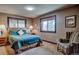 Comfortable bedroom with plush blue comforter, side tables and an accent chair at 185 S Fuller Placer Rd, Breckenridge, CO 80424