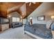 Spacious bedroom with wood-paneled ceiling, sitting area, and large windows for natural light at 185 S Fuller Placer Rd, Breckenridge, CO 80424