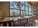 Dining room with a large wooden table and floor-to-ceiling windows showcasing a mountain view at 185 S Fuller Placer Rd, Breckenridge, CO 80424