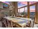 Dining room with antler chandelier and custom table with mountain views at 185 S Fuller Placer Rd, Breckenridge, CO 80424