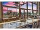 Bright dining room with a large custom table and floor to ceiling windows offering mountain views at 185 S Fuller Placer Rd, Breckenridge, CO 80424