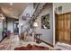 Inviting entryway boasts travertine floors, staircase, and a cozy seating area with a leather chair at 185 S Fuller Placer Rd, Breckenridge, CO 80424