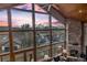 Living room with floor-to-ceiling windows offering a beautiful mountain view and a stone fireplace at 185 S Fuller Placer Rd, Breckenridge, CO 80424