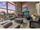 Expansive living room featuring a stone fireplace, TV and mountain views at 185 S Fuller Placer Rd, Breckenridge, CO 80424