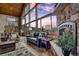 Cozy living room with stone fireplace, comfortable seating, and large windows at 185 S Fuller Placer Rd, Breckenridge, CO 80424