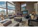 Living room with stone fireplace, plush sofas, and large windows with mountain views at 185 S Fuller Placer Rd, Breckenridge, CO 80424