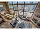 Spacious living room featuring a stone fireplace, large windows, and comfortable seating at 185 S Fuller Placer Rd, Breckenridge, CO 80424