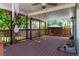 Covered back deck with a ceiling fan and string lights, perfect for outdoor relaxation and dining at 6150 Reed St, Arvada, CO 80003