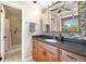 Bathroom featuring a modern vanity with elegant tiling, and a walk-in shower with glass doors at 6150 Reed St, Arvada, CO 80003