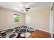 Bedroom with light walls, a ceiling fan, a window view, and carpeted flooring at 6150 Reed St, Arvada, CO 80003