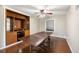 Dining room boasts a large wooden table, built in wood cabinets, and hardwood flooring at 6150 Reed St, Arvada, CO 80003
