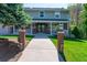 Inviting front of a two-story home featuring a brick walkway, porch, and well-maintained lawn at 6150 Reed St, Arvada, CO 80003