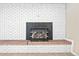 Close-up of a white brick fireplace with a dark mantel at 6150 Reed St, Arvada, CO 80003