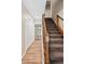 Bright hallway with hardwood floors, stairs, and a glimpse of the outdoors at 6150 Reed St, Arvada, CO 80003