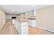 Spacious kitchen boasts an island, recessed lighting, and wooden floors at 6150 Reed St, Arvada, CO 80003