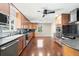 Kitchen with wood cabinets, stainless appliances and a breakfast nook area with a window at 6150 Reed St, Arvada, CO 80003